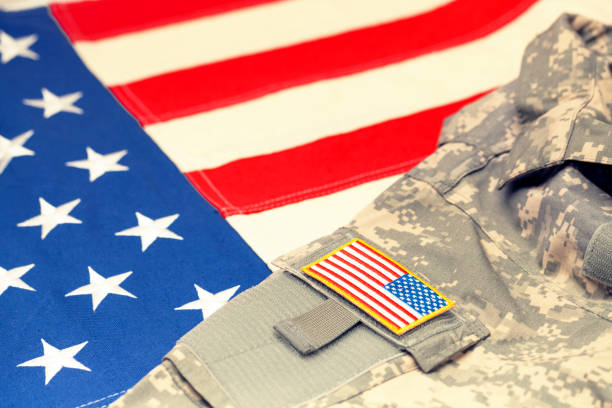 istock USA army uniform with chevron over flag. Filtered image: cross processed vintage effect. 698955472