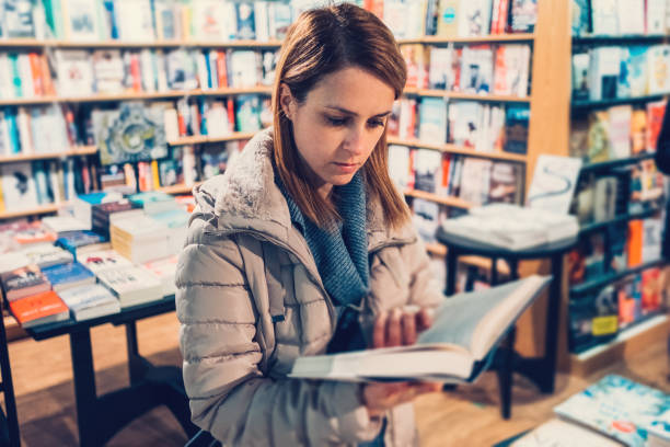 istock University student in the bookstore reading a book 698970948