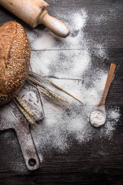 istock Fresh bread on a wooden background 698971776