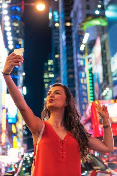 istock Beautiful woman using phone in Times Square. 698971824