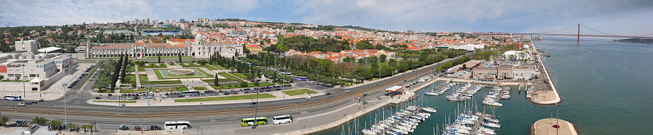 Bird eye view panorama of Belem district with Hieronymites Monastery and 25th of April Bridge over Tagus river in Lisbon, Portugal