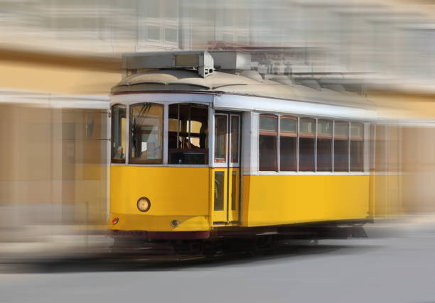 Traditional tram with motion blur on the background of the Lisbon city, Portugal
