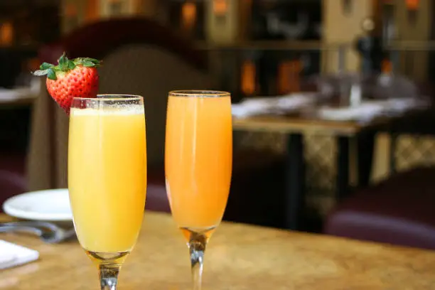 Two mimosa cocktail glasses, horizontal