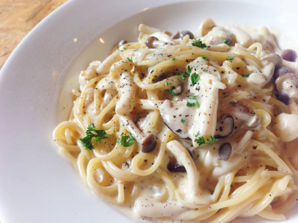 istock Mushroom spaghetti on wooden table - top view 699023984