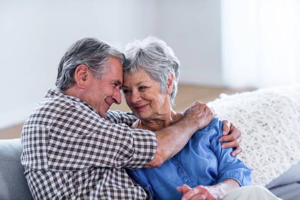 istock Happy senior couple embracing each other on sofa 699059150