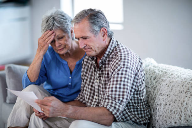 istock Worried senior couple checking the bills 699067210
