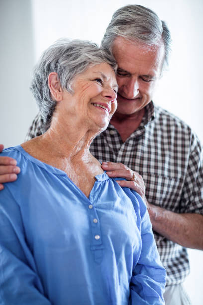 istock Happy senior couple standing together and smiling 699069582
