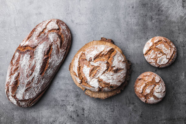 istock Delicious fresh bread on wooden background 699069630