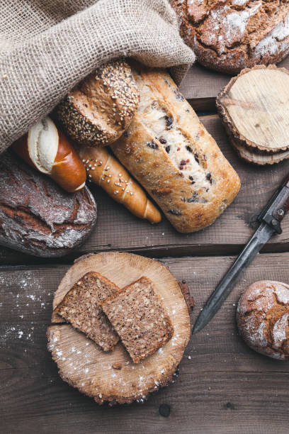 istock Delicious fresh bread inside a sack on wooden background 699070792