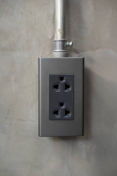 istock Electricity plug on industrial concrete wall background 699093032