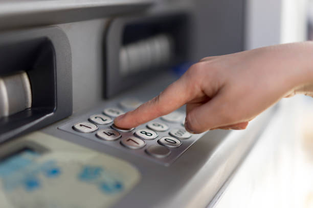 istock Woman withdraws money from an atm 699093270