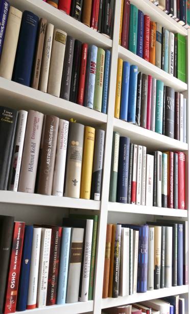 istock View of white fully filled book shelves 699093424