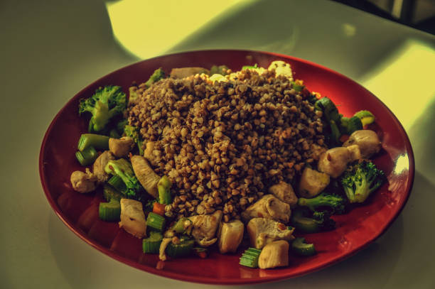 Woman is holding in her hands brown rice