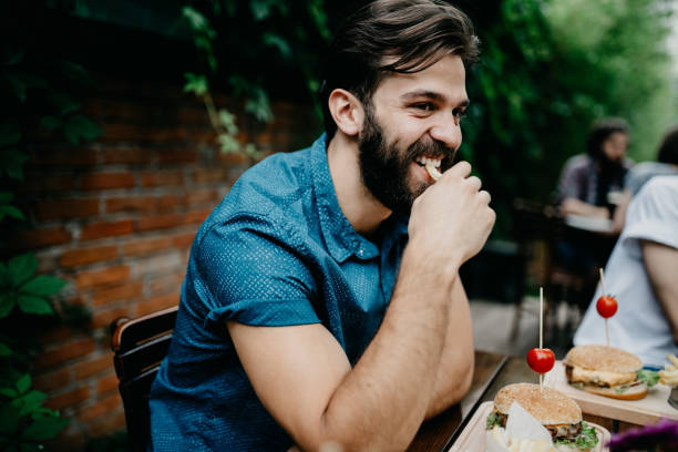 istock Happy man eating fries at the pub 699098416