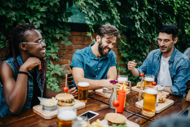 istock Happy multi-ethnic friends at the pub are having a lunch 699100670