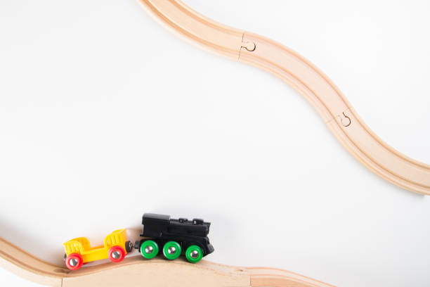 istock Toy train and wooden rails on white background. Top view. 699106800