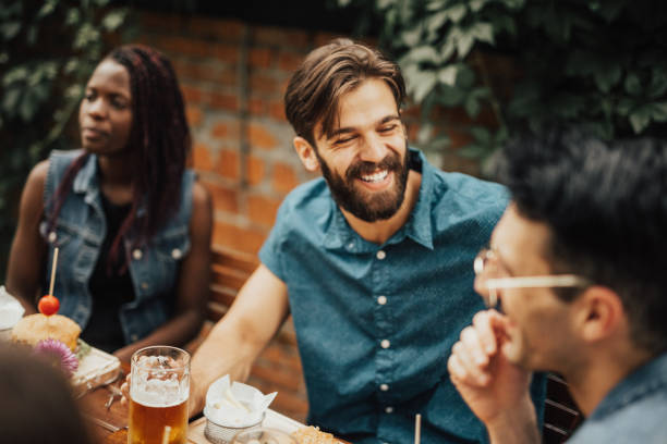 istock Happy hipster drinking beer at the pub with his friends 699111526