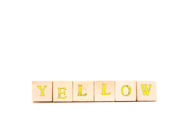 istock YELLOW: Written in Yellow Wood Block Letters, White Background 699125768