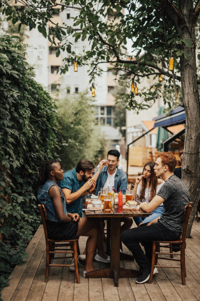 istock Multi-ethnic group of people eating at the pub 699133992