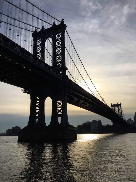 istock Low Angle View Of Silhouette Manhattan Bridge Over East River During Sunset 699153741