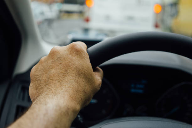 istock Cropped Hand Of Man Driving Car 699161935