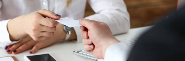 istock Female hand in suit give blank calling card 699163060