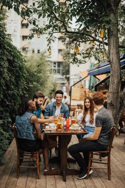 istock Smiling multi-ethnic group of people having fun at the pub 699174538