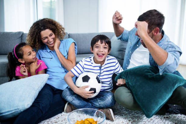 istock Family watching match together on television 699177382