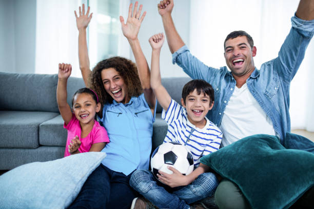 istock Family watching match together on television 699177676