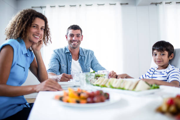 istock Family sitting at breakfast table 699177728