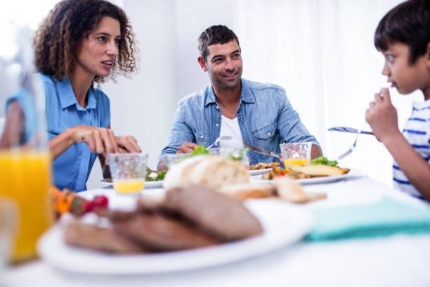 istock Family sitting at breakfast table 699178856