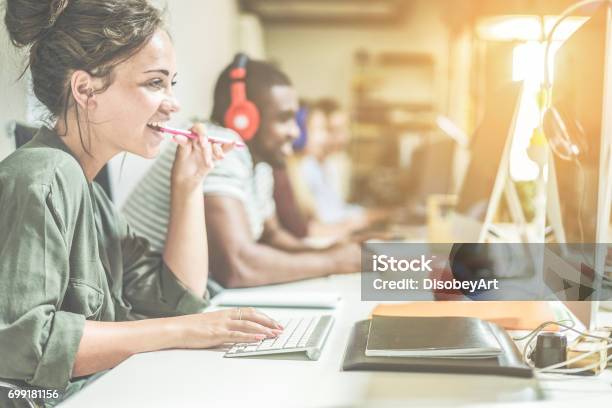Young Trendy Teamwork Using Computer In Creative Office Business People Working Together At Web Site Project Focus On Woman Right Hand Technology Job Concept Contrast Retro Filter Stock Photo - Download Image Now