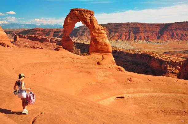 istock Women walking to Delicate Arch USA 699185562