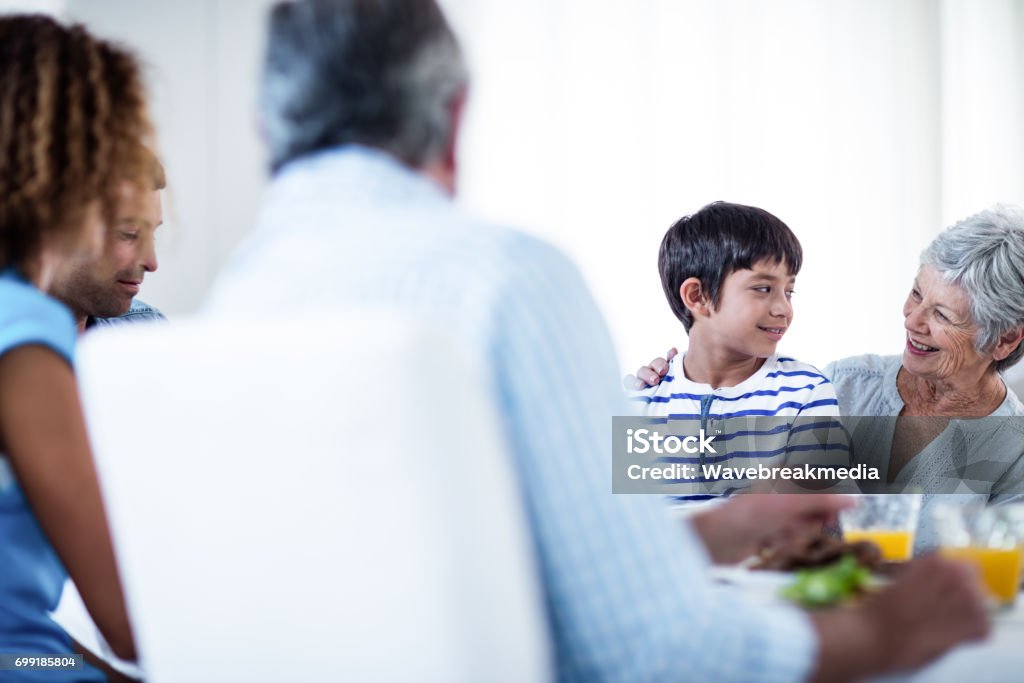 Grandmother and grandson having breakfast with family Grandmother and grandson having breakfast with family at home 20-29 Years Stock Photo