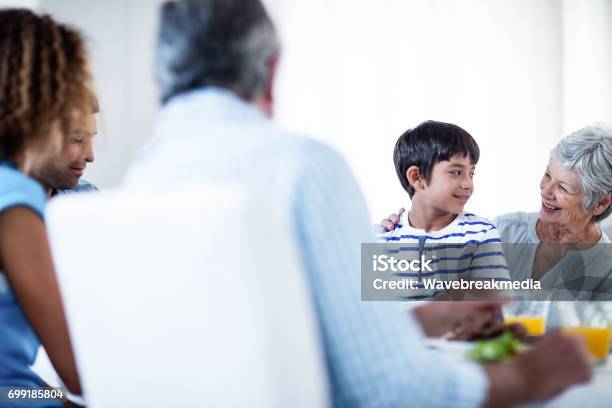 Grandmother And Grandson Having Breakfast With Family Stock Photo - Download Image Now