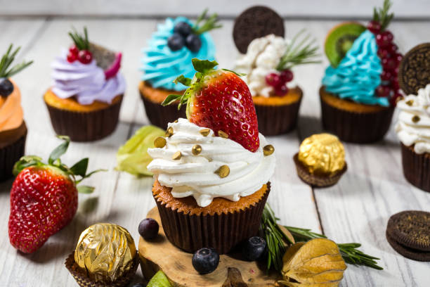 istock Chocolate cupcakes. Cupcakes. Cupcakes with berries,fruit,strawberries. Top view.colorful cupcake,tasty cake,colorful cream,candies,cupcakes with summer berries on wooden background,close up,dessert concept 699195104