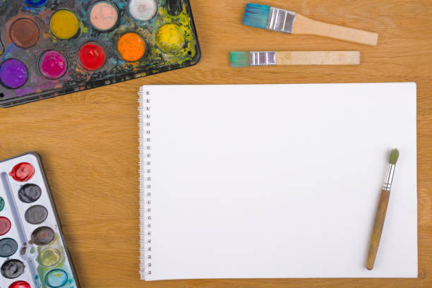 istock Old box with watercolors and brushes on wooden background 699221088