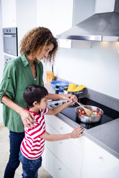 istock Mother and son cooking in kitchen 699229946