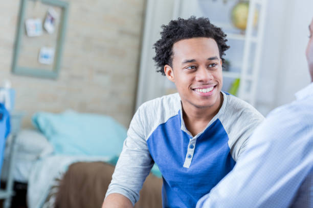 istock Handsome teenage boy talks with his dad 699251022