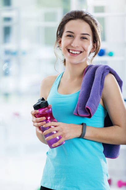 istock Young woman takes water break after exercise 699251078