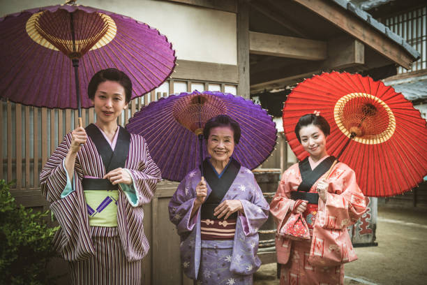 geisha and geishas in training together - make up women ceremonial makeup senior women imagens e fotografias de stock