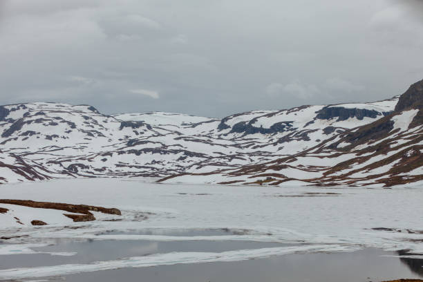 istock Norway scenic mountains with frozen lake. 699281590