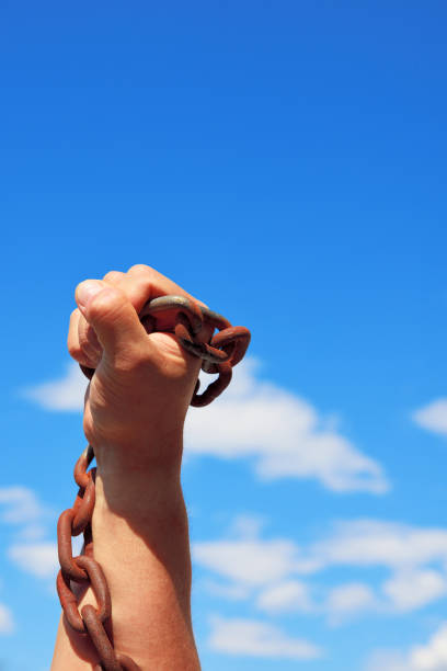 istock male hand holds a rusty metal chain 699286790