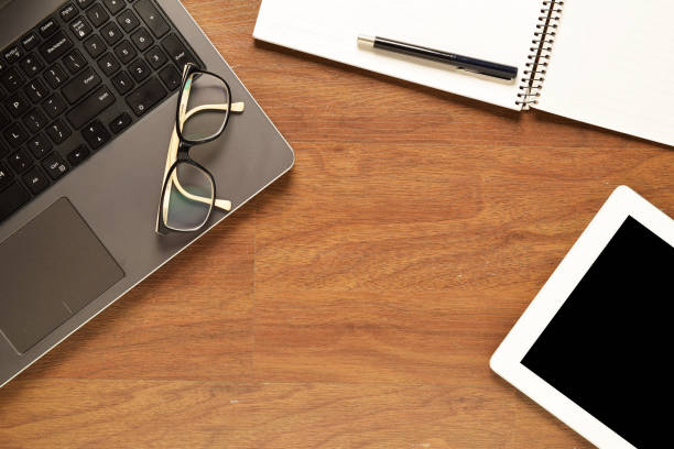 istock Tablet and other items on a wooden desk 699287764