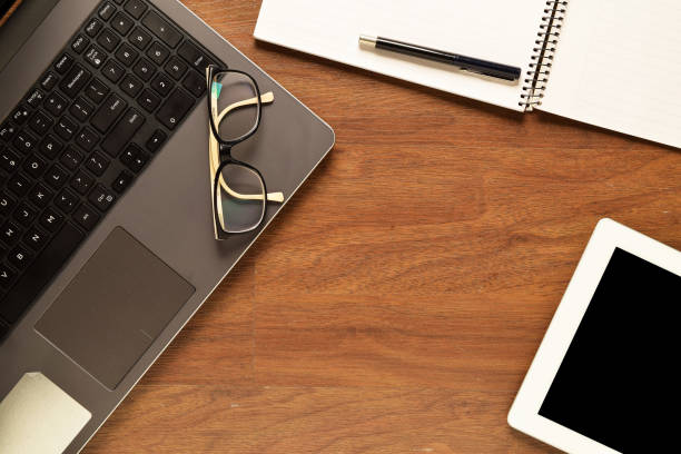istock Tablet and other items on a wooden desk 699294690