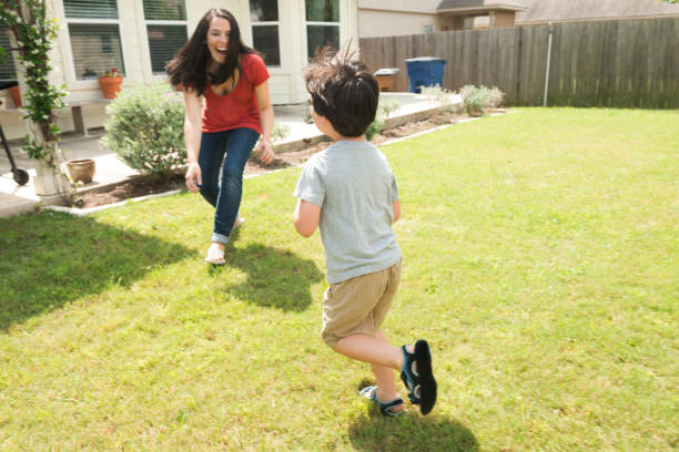 istock Millennial Mother Playing Chase with Son in Suburban Austin Backyard 699308032