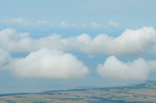 Aerial scenery of cumulus clouds over mountains with blue sky background.