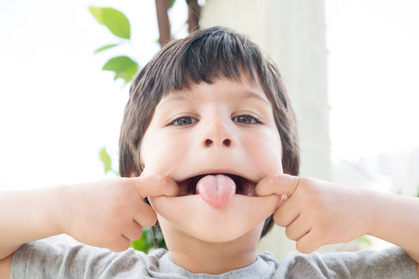 istock Silly Little Boy Making a Face Outside in Backyard 699353154