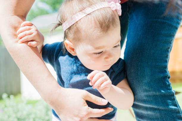 Mother with Baby Learning to Walk in Backyard USA