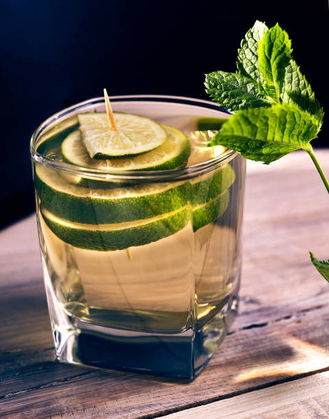 istock Glass with green transparent lime drink and mint. 699377366